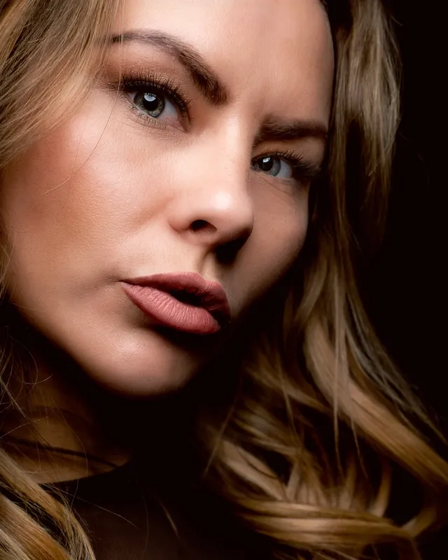 Beauty close-up on a dark background, retouched by hand