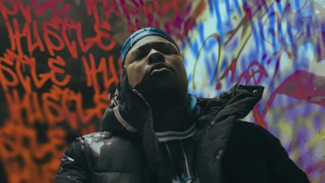 Młody Olisadebe in front of a graffiti wall, Hustle
